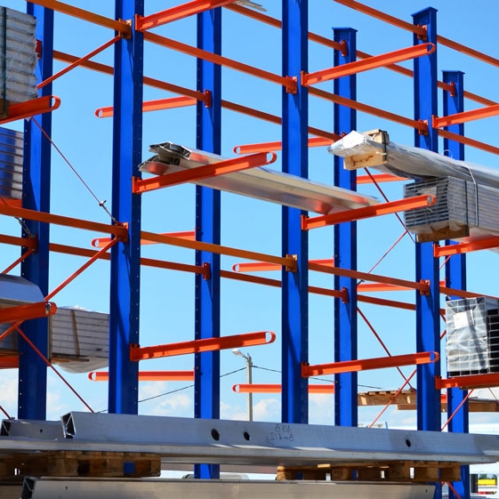 Cantilever racking installed in builders merchant yard, storing long timber sheets