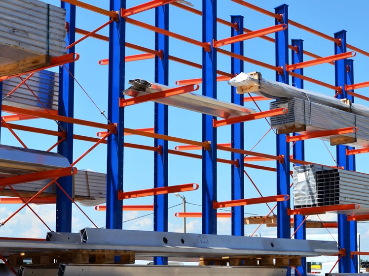 Cantilever racking installed in builders merchant yard, storing long timber sheets