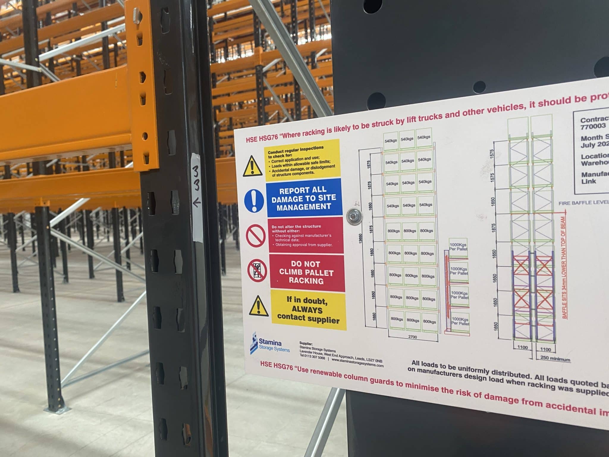 A load notice fixed to an installled pallet racking system, to show weight capacities.