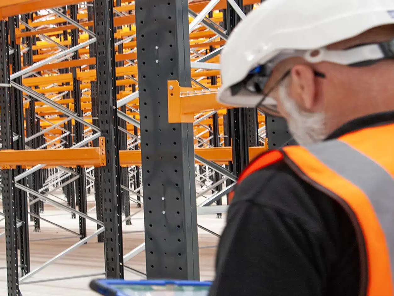 team member inspecting racking