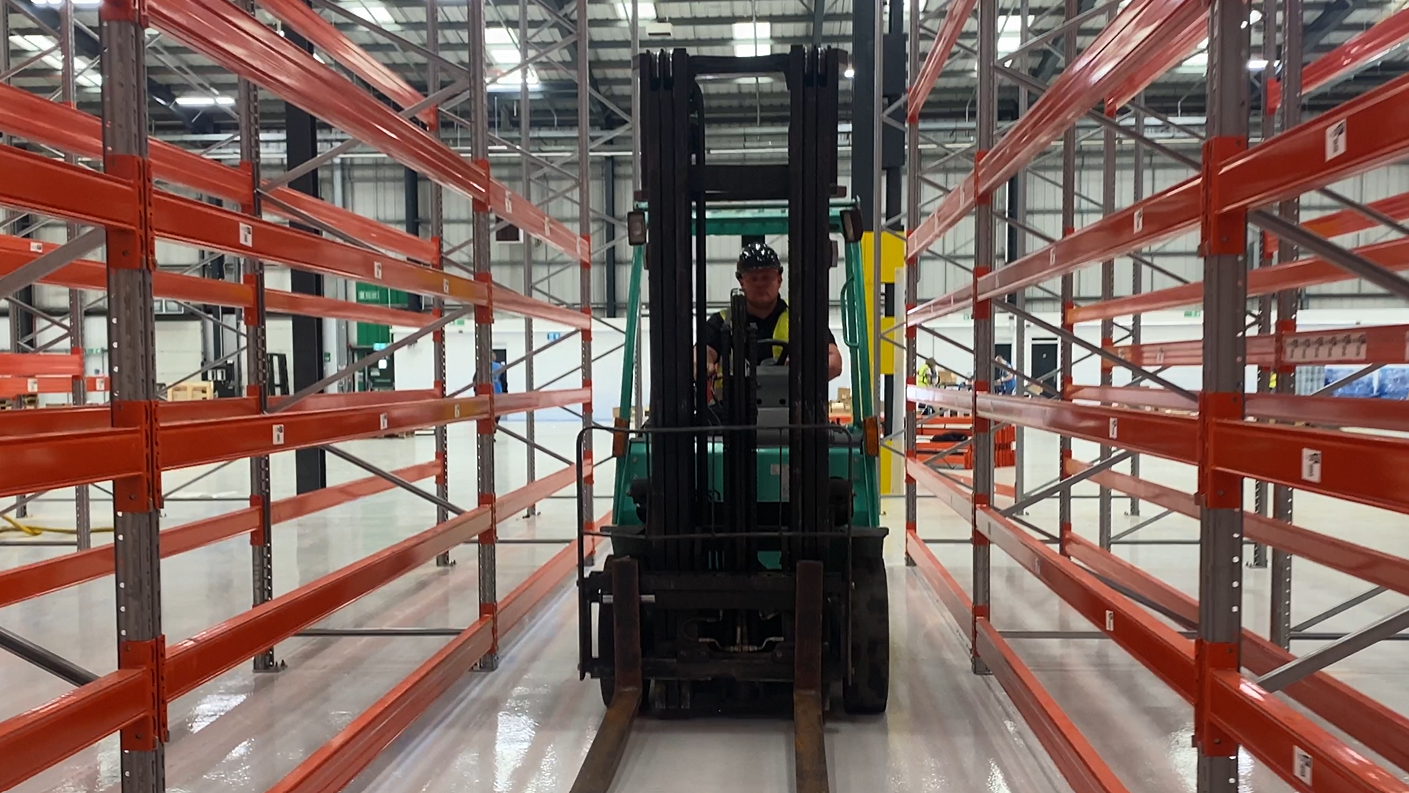 forklift in-between pallet racking